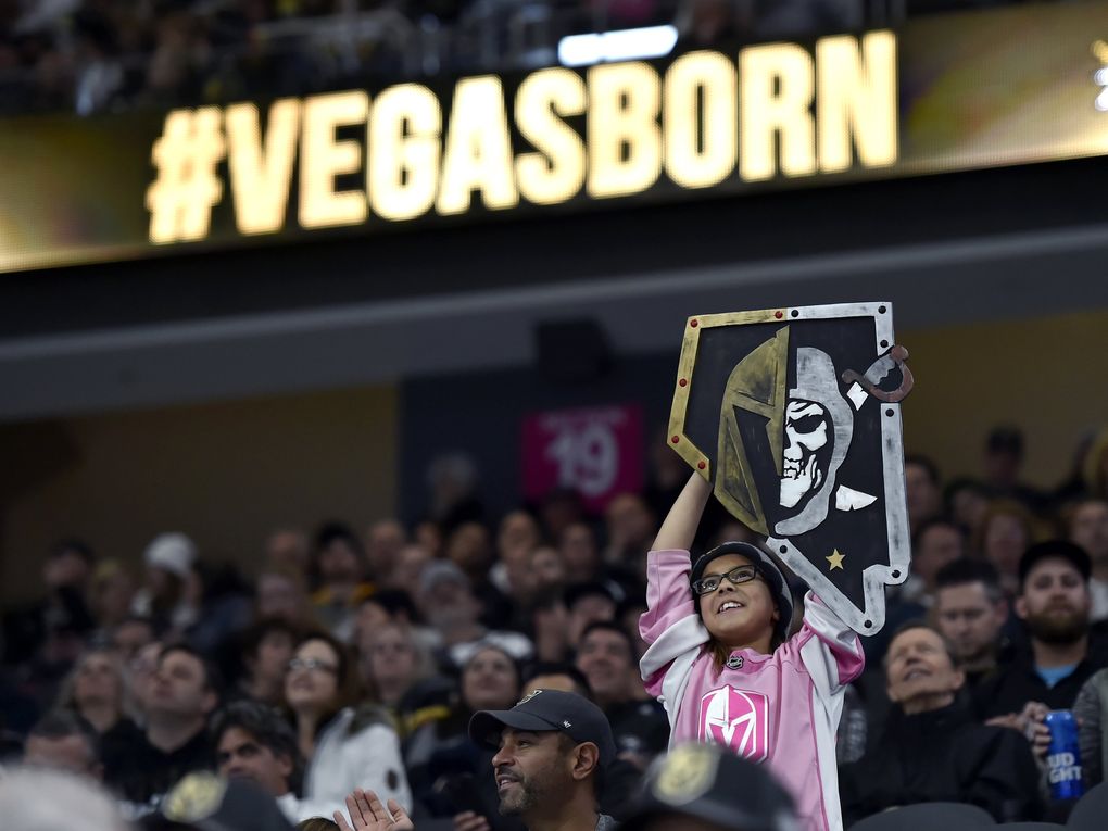 A young fan cheers during the first period of a Vegas Golden Knights game. (AP Photo/David Becker)