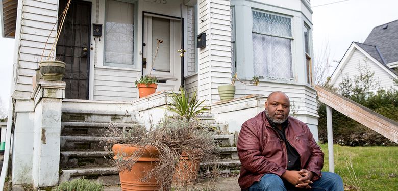 Inye Wokoma’s grandfather bought this house in the Central District in 1947. Wokoma wants his children to inherit it, history they can see and touch. But lately the house has felt like an island. “The Central District as I knew it is gone,” he says. (Courtney Pedroza / The Seattle Times)