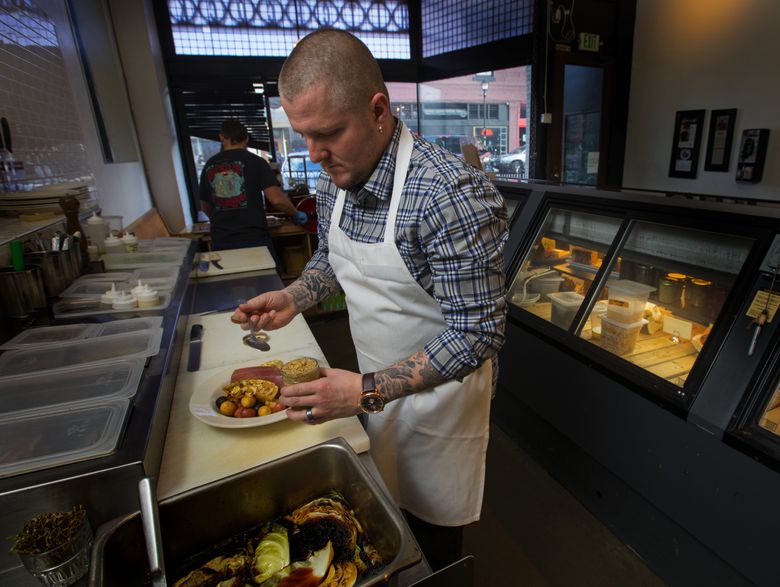 McGill prepares corned beef and cabbage at his Georgetown deli. Making the dish and eating it was a casual thing in his household until he was an adult. “I really took it on when I was 17 or 18, living by myself and cooking at home a lot.”  (Ellen M. Banner/The Seattle Times)