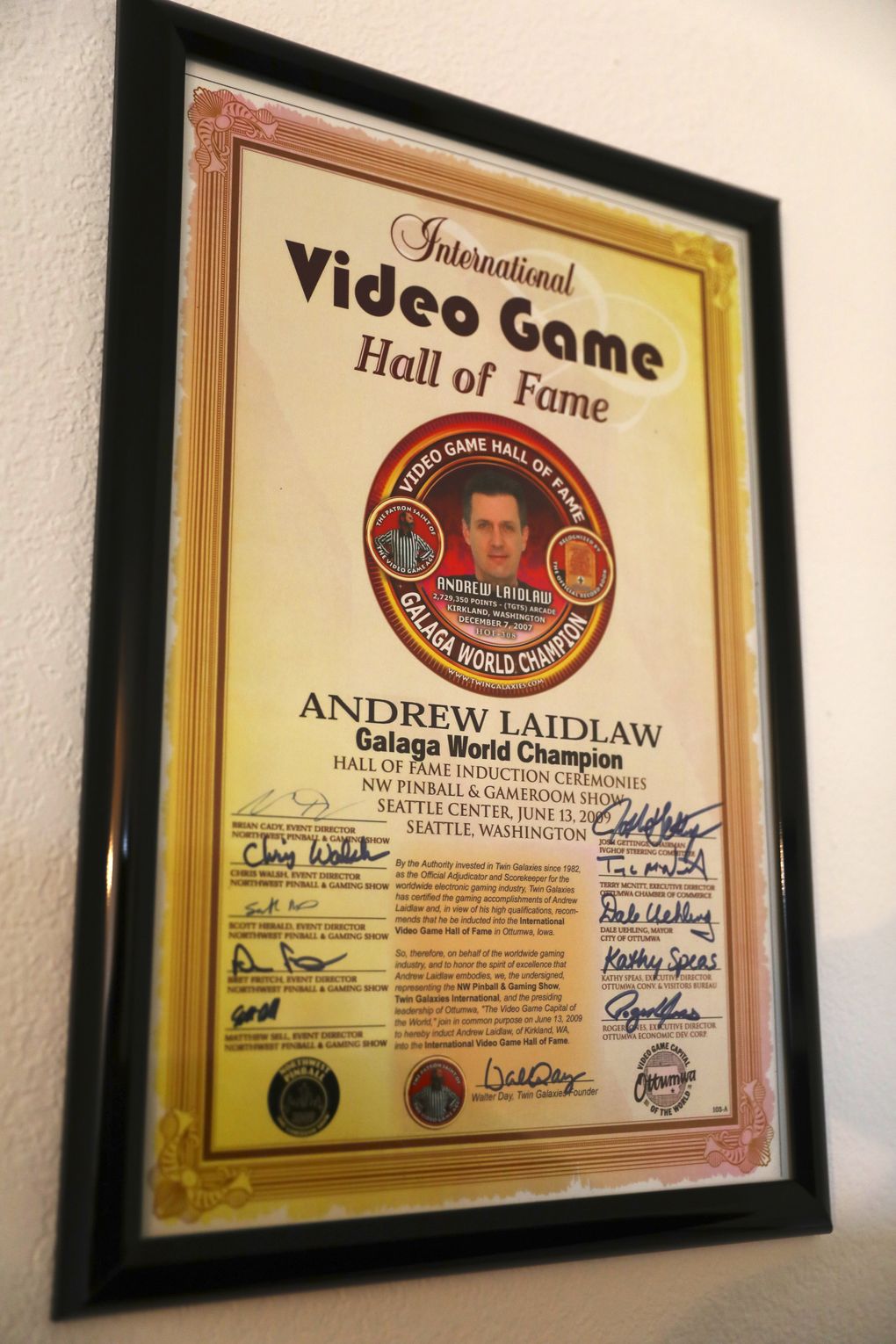 Andrew Laidlaw has the plaque that proves he’s the world record holder in Galaga on his wall at home in Kirkland. (Ken Lambert/The Seattle Times)