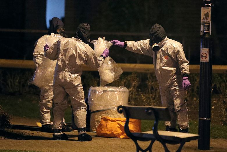 Investigators in protective suits work at the scene in Salisbury, England, on March 13. The use of Russian-developed nerve agent Novichok to poison ex-spy Sergei Skripal and his daughter makes it “highly likely” that Russia was involved, British Prime Minister Theresa May said. (Andrew Matthews/PA via AP)