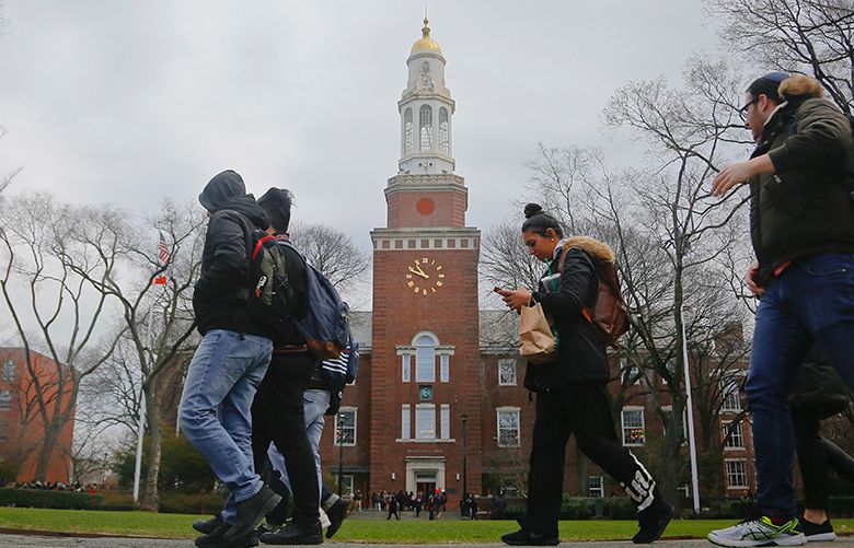 Brooklyn College students walk between classes on campus in New York. (Bebeto Matthews / AP file photo)