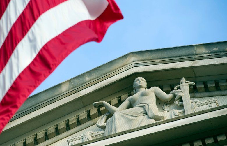 FILE – In this Nov. 2016 file photo, the American Flag flies outside the Justice Department in Washington. A new team of federal agents is targeting online trafficking of illicit fentanyl, which is driving a rising number of overdose deaths across the U.S. Darknet drug sales are proving a challenge to law enforcement that can be more vexing than even drug cartels. The crackdown is part of the Trump administrationâ€™s tough approach to the drug crisis that some critics say resembles a return to failed drug war tactics. But there is bipartisan agreement on the need to do more against online drug dealing.  (AP Photo/Cliff Owen) WX102 WX102