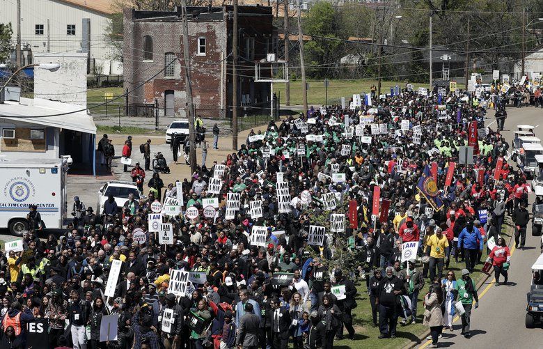 People take part in a march commemorating the anniversary of the assassination of Rev. Martin Luther King Jr. Wednesday, April 4, 2018, in Memphis, Tenn. King was assassinated April 4, 1968, while in Memphis supporting striking sanitation workers. (AP Photo/Mark Humphrey) TNMH113 TNMH113