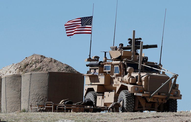 FIEL – In this April 4, 2018, file photo, a U.S. soldier sits on an armored vehicle on a newly installed position, near front line between the U.S-backed Syrian Manbij Military Council and the Turkish-backed fighters, in Manbij, north Syria. The drama of U.S. and allied missiles strikes on Syria has obscured the fact that the U.S.-led campaign to eliminate the Islamic State from Syria has stalled. This is an illustration of the many-layered complexities of the Syrian conflict.  (AP Photo/Hussein Malla, File) WX123 WX123