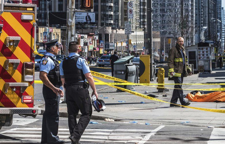 A body lies covered on the sidewalk in Toronto after a van mounted a sidewalk crashing into a number of pedestrians on Monday, April 23, 2018.A van apparently jumped a curb Monday in a busy intersection in Toronto and struck numerous people and fled the scene before it was found and the driver was taken into custody, Canadian police said.  (Aaron Vincent Elkaim/The Canadian Press via AP) AVE101 AVE101