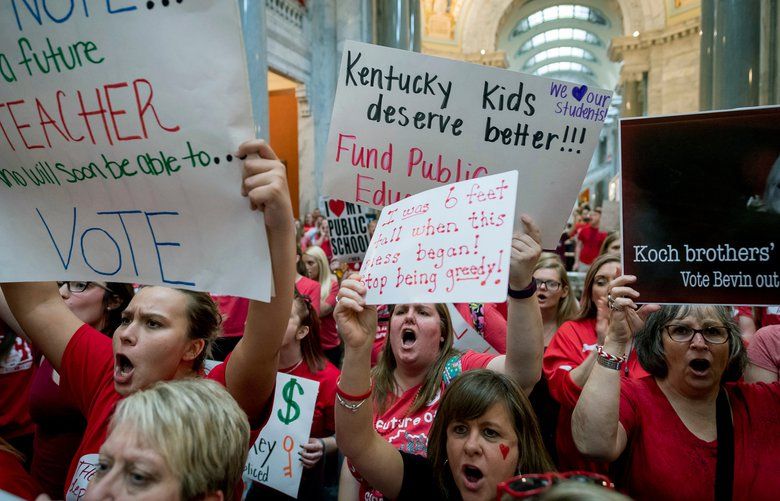 FILE – In this Friday, April 13, 2018 file photo, teachers from across Kentucky gather inside the state Capitol in Frankfort, Ky., during a rally for increased education funding.  Americans overwhelmingly believe teachers don’t make enough money, and half say they’d support paying higher taxes to give educators a raise. That’s according to a new poll from The Associated Press-NORC Center for Public Affairs Research that comes amid recent teacher strikes over low pay and the amount of money allocated to public schools in several Republican-led states. The poll found that parents and those without children are about as likely to think teachers are paid too little.   (AP Photo/Bryan Woolston) WX101 WX101