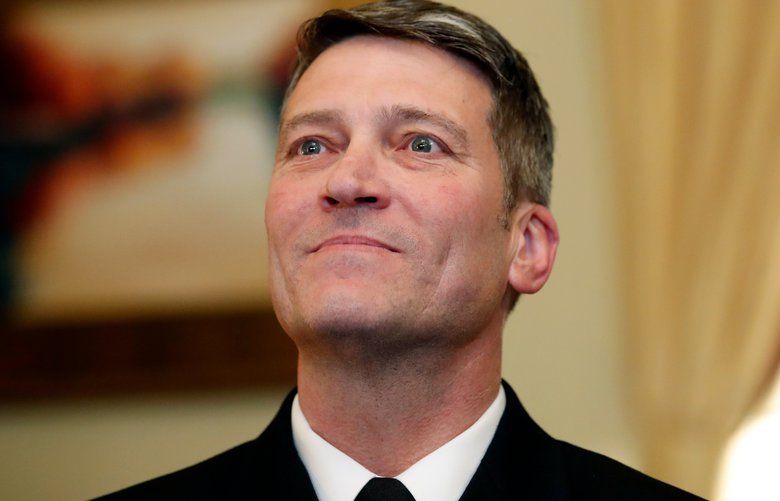 In this April 16, 2018, photo, U.S. Navy Rear Adm. Ronny Jackson, M.D., sits with Sen. Johnny Isakson, R-Ga., chairman of the Veteran’s Affairs Committee, before their meeting on Capitol Hilin Washington. Jackson is President Donald Trump’s nominee to be the next Secretary of Veterans Affairs. Now it’s Washington’s turn to examine Jackson. The doctor to Presidents George W. Bush, Barack Obama and now Donald Trump is an Iraq War veteran nominated to head the Department of Veterans Affairs. (AP Photo/Alex Brandon) WX205 WX205