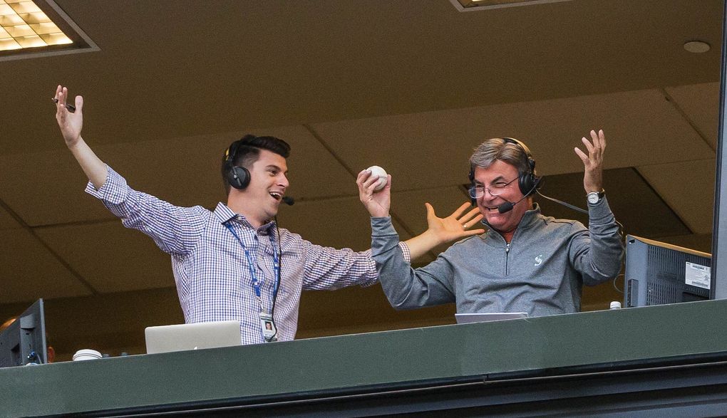 Mariners announcer Rick Rizzs, right, was the unlikely recipient of a foul ball during a 2016 game against the Red Sox. (Dean Rutz/The Seattle Times)
