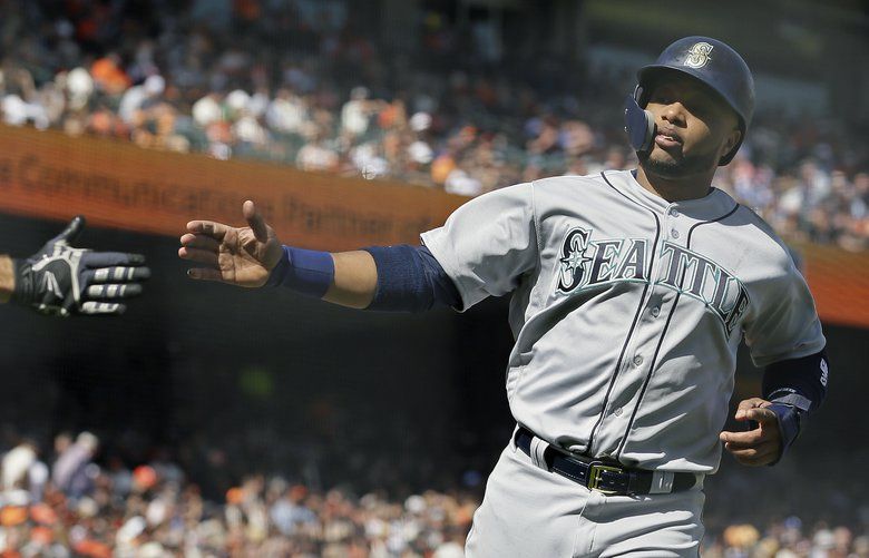 Seattle Mariners' Robinson Cano swings at a pitch in front of