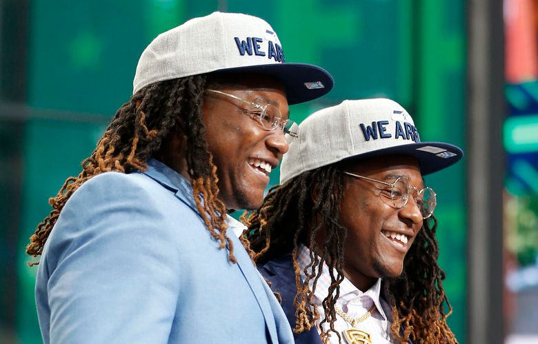 Shaquem Griffin, left, and his twin brother Seattle Seahawks cornerback Shaquill Griffin pose for a photograph on stage during the NFL football draft in Arlington, Texas, Saturday, April 28, 2018. The Seahawks selected Shaquem in the fourth round. (Jae S. Lee/The Dallas Morning News via AP) TXDAM902 TXDAM902