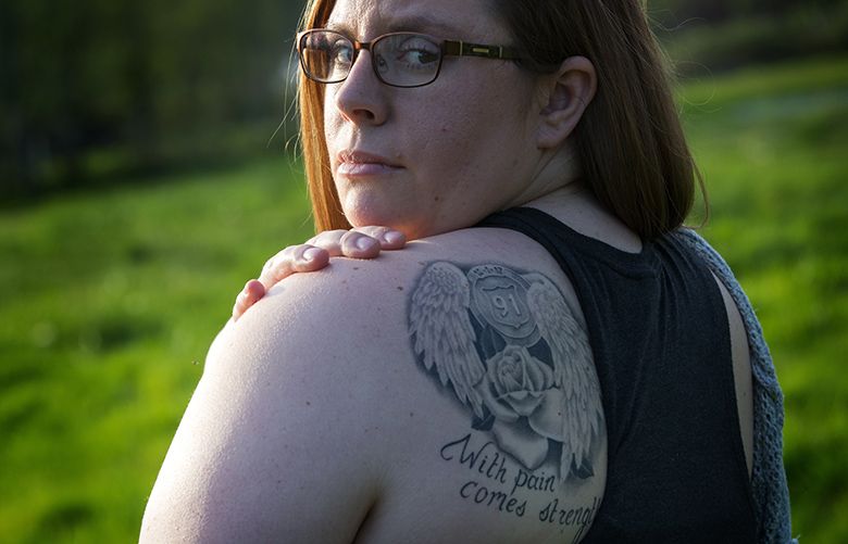Alicia Johnston shows a tattoo she got in remembrance of the victims of the Las Vegas shooting at her home in Sultan, Tuesday, April 24, 2018.   Alicia Johnston was shot in the back in Vegas and survived.