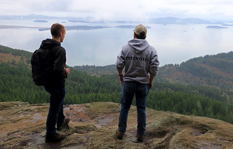 Hikers enjoy the view of the San Juan Islands from Oyster Dome. John Nelson photo