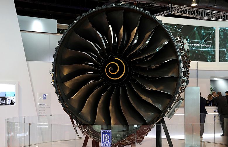 An attendee walks past a Rolls-Royce Holdings Plc Trent 1000 aircraft engine on display at the Singapore Airshow in Singapore, on Wednesday, Feb. 7, 2018. The air show runs through Feb. 11. Photographer: SeongJoon Cho/Bloomberg