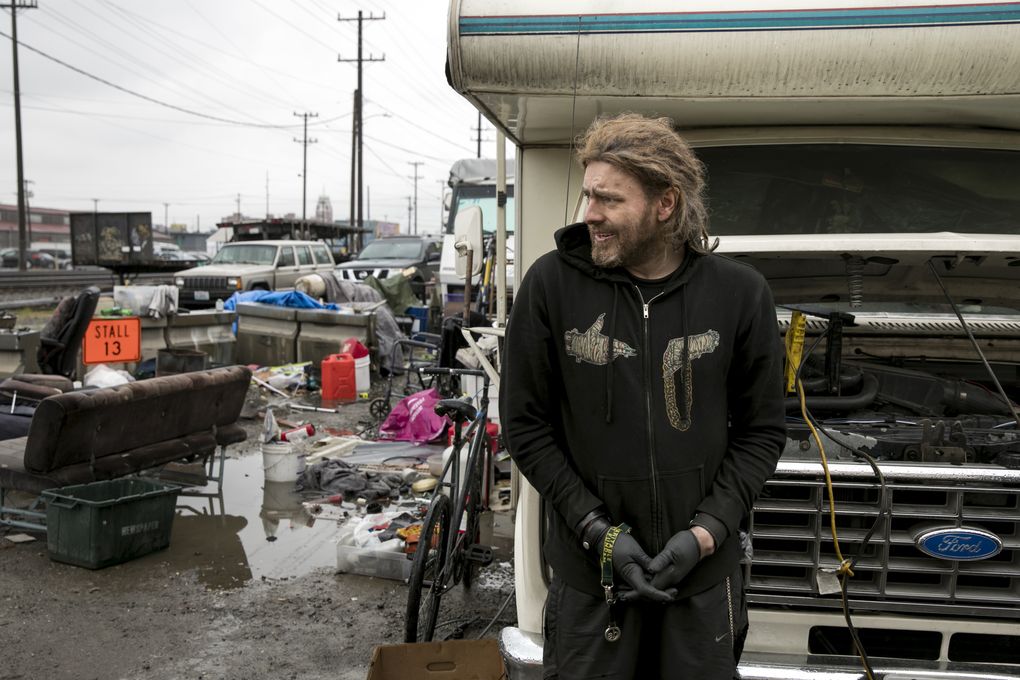 Matt Irvin, 36, said that he has been staying in the safe zone for about three weeks. “They told me you can’t park here, that you need a permit,” he said of the outreach worker who first approached him. “They told me, well, I can’t get one, that they’re shutting down the program.” Eight permitted RVs remain in the Sodo lot. (Bettina Hansen/The Seattle Times)