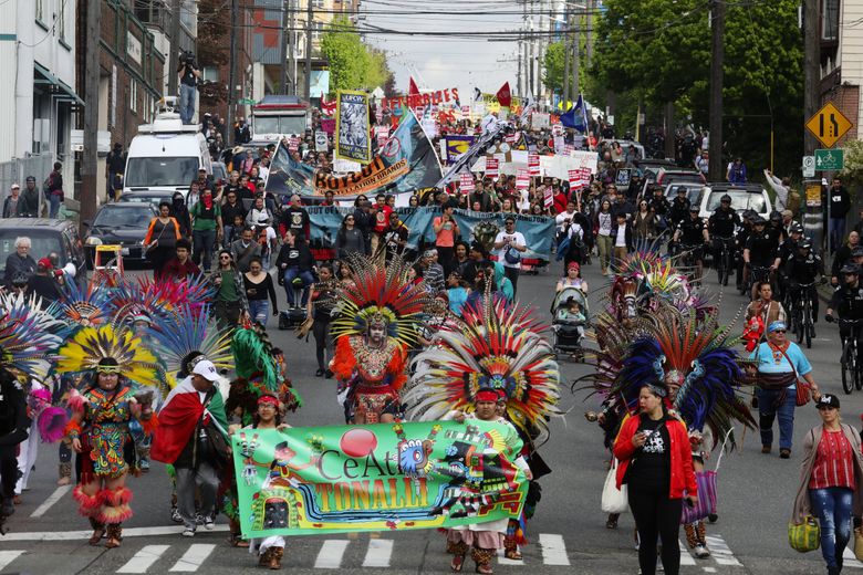The May Day March for Immigrant and Workers Rights heads down Jackson Street. (Ken Lambert / The Seattle Times)
