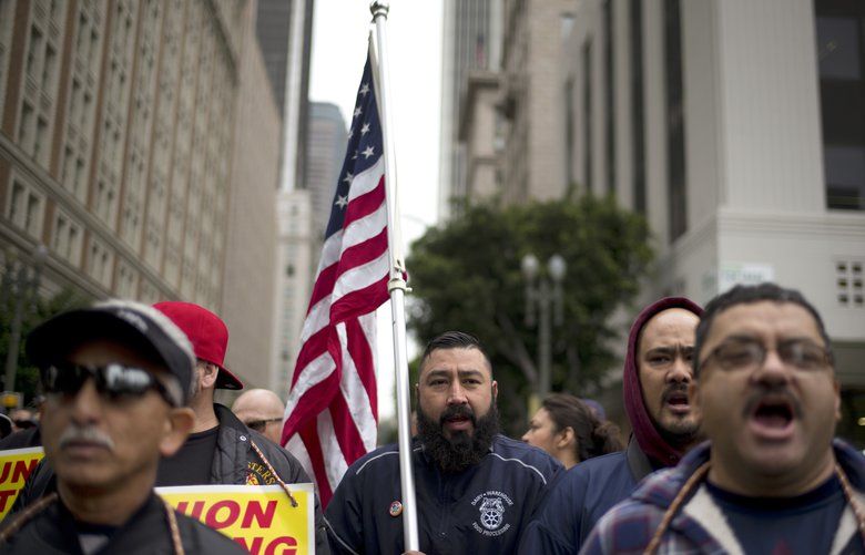 Protesters chant slogans during a May Day rally Tuesday, May 1, 2018, in Los Angeles. Immigrants say President Donald Trump’s administration has become almost everything they feared, but while they rally across the United States on May Day, their focus is less on huge turnout Tuesday than on the first Tuesday in November. (AP Photo/Jae C. Hong) CAJH101 CAJH101