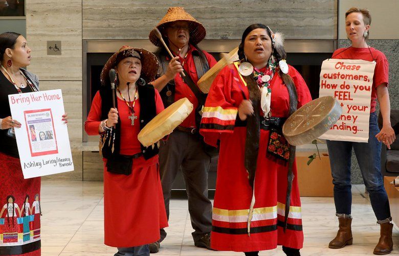 On May 7, 2018, opponents of the trans mountain pipeline gather in the lobby of the Ruissell Investments building, outside the entrance to a Chase bank branch. 