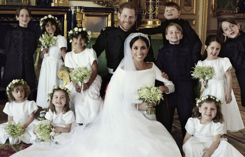 In this photo released by Kensington Palace on Monday May 21, 2018, shows an official wedding photo of Britain’s Prince Harry and Meghan Markle, center, in Windsor Castle, Windsor, England, Saturday May 19, 2018. Others in photo from left, back row, Brian Mulroney, Remi Litt, Rylan Litt, Jasper Dyer, Prince George, Ivy Mulroney, John Mulroney; front row, Zalie Warren, Princess Charlotte, Florence van Cutsem. (Alexi Lubomirski/Kensington Palace via AP) LON817 LON817