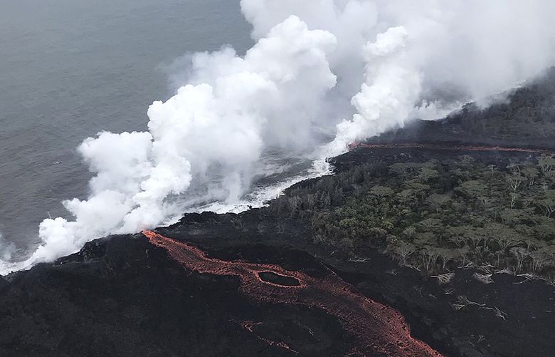 This image provided by the U.S. Geological Survey shows lava as it continues to enter the sea at two locations near Pahoa, Hawaii, Monday, May 21, 2018. Lava from Hawaii’s Kilauea volcano is pouring into the sea and setting off a chemical reaction that creates giant clouds of acid and fine glass. (U.S. Geological Survey via AP) FX906 FX906 ( / The Associated Press)