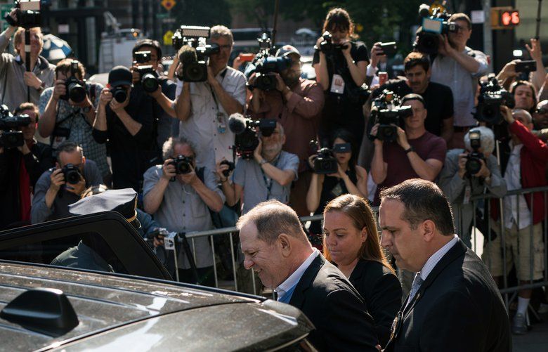 A handcuffed Harvey Weinstein is led out of a police station in lower Manhattan following his arrest on Friday morning, May 25, 2018. Weinstein was arrested by detectives on Friday on charges that he raped one woman and forced another to perform oral sex, capping a lengthy inquiry into the avalanche of accusations against him that spawned a public reckoning, and, with it, the global #MeToo movement. (Todd Heisler/The New York Times) XNYT4 XNYT4