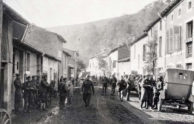 This photo provided by National World War I Museum and Memorial and dated Sept. 20, 1918, shows American soldiers in Bouillonville, eastern France, and the hill in the background which protects the village from German shells. Bouillonville was the center of the medical unit for a large part of the German Army. Many medical supplies were found and our medical units were using the German hospitals the same day the drive started. (National World War I Museum and Memorial via AP) LON505 LON505