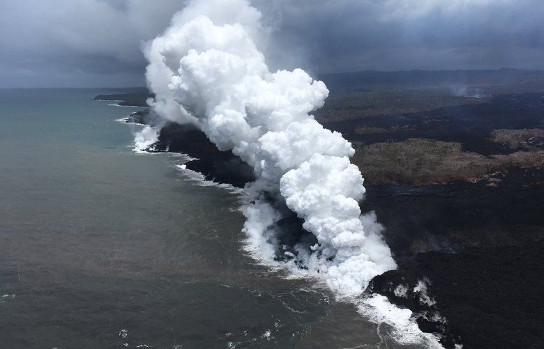 In this Saturday, May 26, 2018 image from video released by the U.S. Geological Survey, lava sends up clouds of steam and toxic gases as it enters the Pacific Ocean as Kilauea Volcano continues its eruption cycle near Pahoa on the island of Kilauea, Hawaii. Lava from the Kilauea volcano has reached a geothermal power plant on the Big Island, approaching wells that have been capped to protect against the release of toxic gas should they mix with lava. (U.S. Geological Survey via AP) LA701 LA701