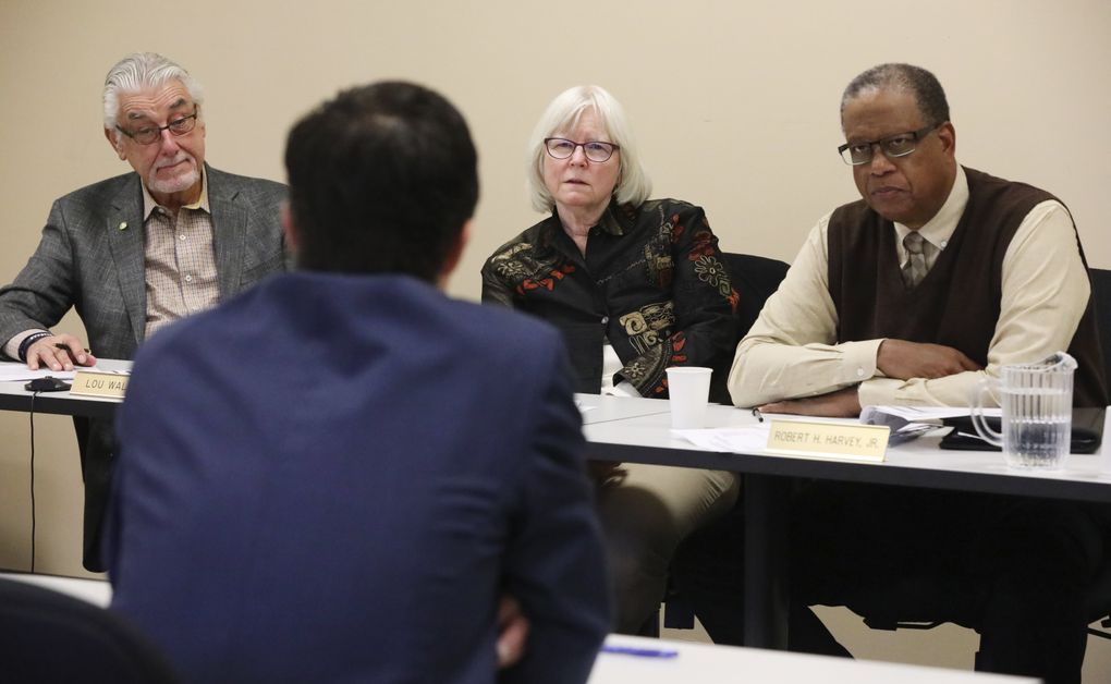 Board members for the Seattle City Employees’ Retirement System, from left, Lou Walter, Jean Becker and Robert Harvey Jr., listen to Jason Malinowski, chief investment officer, during a meeting in November. (Ken Lambert/The Seattle Times)