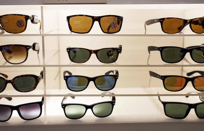Ray-Ban luxury sunglasses, manufactured by Luxottica Group SpA, stand on display in an opticians in London, U.K., on Monday, Jan. 16, 2017. French lensmaker Essilor International SA agreed to buy Luxottica Group SpA, the maker of Ray-Ban sunglasses, for about 22.8 billion euros ($24 billion) in stock, combining the largest manufacturer and retailer in eyewear. Photographer: Chris Ratcliffe/Bloomberg 693329841