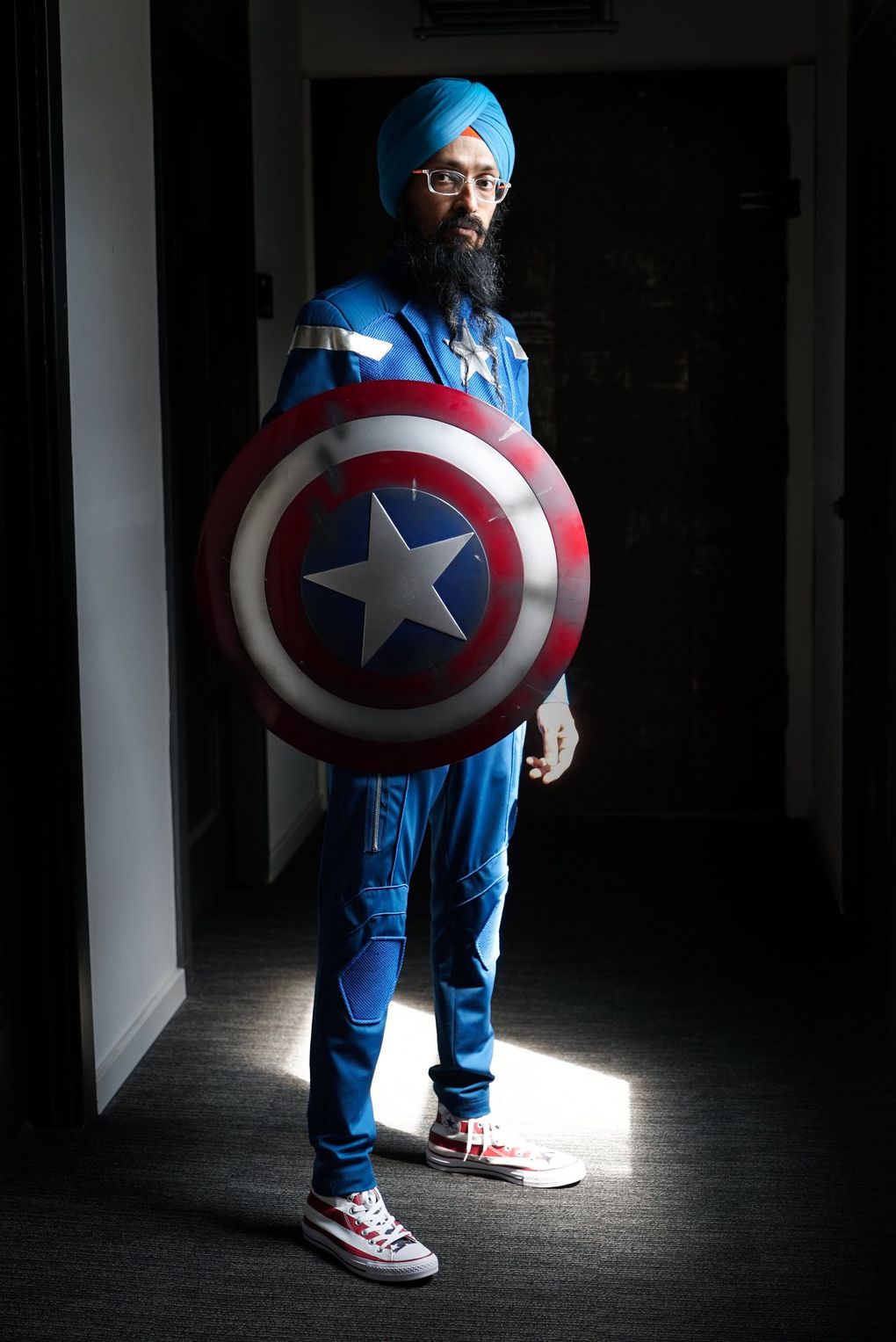 Vishavjit Singh, dressed as Sikh Captain America, uses his superhero alter ego to initiate conversations he would not normally have with others while wearing his civilian clothes. (Corinne Chin / The Seattle Times)
