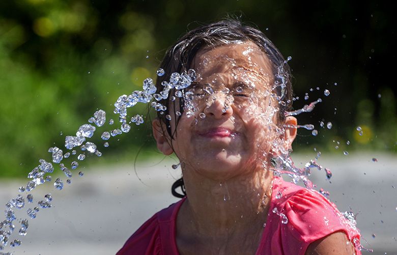 Ruby Barrera, 8, enjoys one of the water features at Jefferson Park Wednesday afternoon, July 19, 2017. She was there with her brother Isaiah, 5 and her mom. They live just down the street so the park is very convenient. There is a chance of rain in Seattle Thursday, but a sunny weekend is expected.