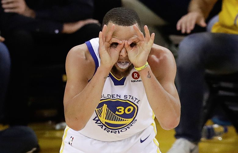 Golden State Warriors guard Stephen Curry (30) celebrates during overtime of Game 1 of basketball’s NBA Finals between the Warriors and the Cleveland Cavaliers in Oakland, Calif., Thursday, May 31, 2018. (AP Photo/Marcio Jose Sanchez)
