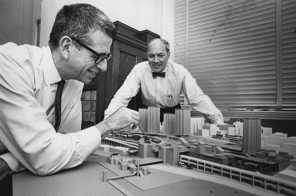 John Morse, left, and Henry Steinhardt view a model of the proposed Pike Plaza redevelopment plan. Morse points to a bridge across the Alaskan Way Viaduct and a smaller pedestrian span leading to the Elliott Bay waterfront. The plan was an effort to draw business away from the malls and suburbs and back into downtown Seattle. (Greg Gilbert/The Seattle Times, 1968)
