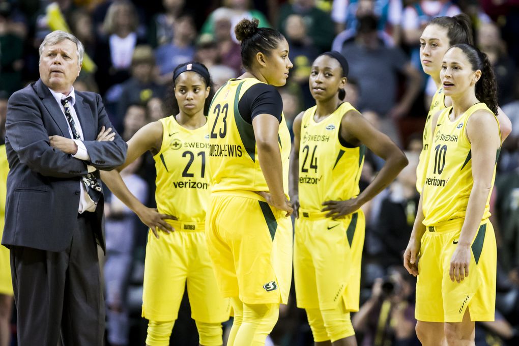 From left, head coach Dan Hughes, guard Jordin Canada, forward Kaleena Mosqueda-Lewis, guard Jewell Loyd, forward Breanna Stewart and guard Sue Bird wait for a referee review in the final moments of the season opener May 20. Down three points in the final moments, they lost possession when Stewart’s foot went out of bounds. (Bettina Hansen / The Seattle Times)