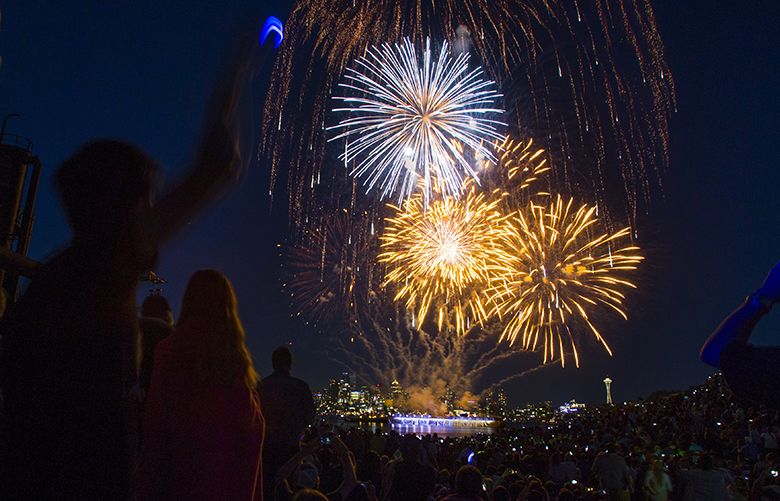 Spectators watch the multi-colored fireworks show on Tuesday, July 4, 2017 at Gas Works Park.
