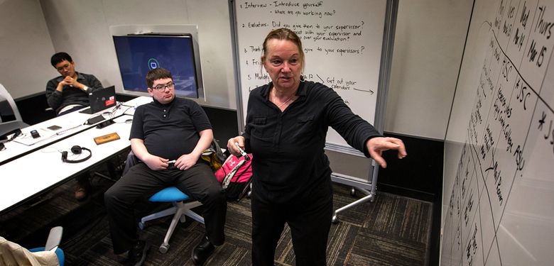 Maggie Meister, with Seattle Public Schools, leads a class at the University of Washington as part of Project Search, which teaches job skills to students with autism. (Ellen M. Banner/The Seattle Times)