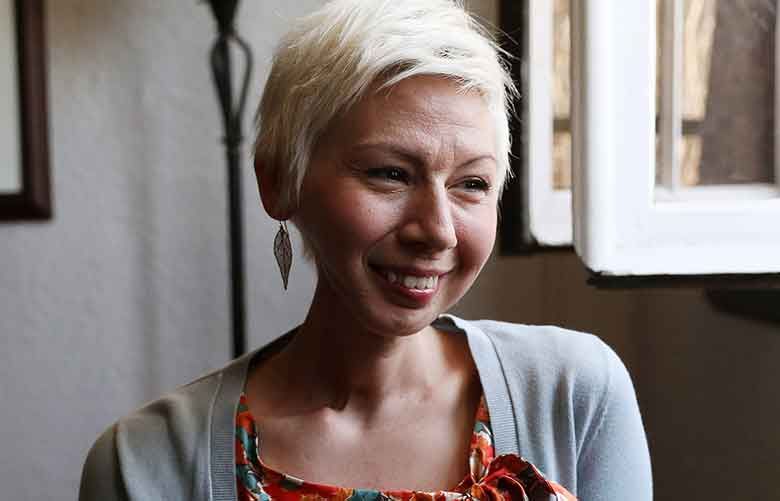 Adrienne Frank, who is recovering from her sixth oral cancer diagnosis in 11 years, is shown in her Minneapolis apartment. Frank was unable to go back to work after her sick leave expired and was subsequently fired by her employer. Although federal law guarantees that those with major illnesses be given time off, that protection only lasts 12 weeks. She lost her income and her health insurance and now at age 35 is covered by Medicaid. (Anthony Souffle / Minneapolis Star Tribune via TNS)