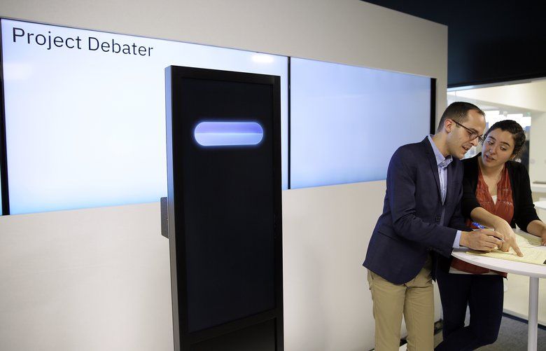 Dan Zafrir, left, and Noa Ovadia, right, prepare for their debate against the IBM Project Debater Monday, June 18, 2018, in San Francisco. IBM on Monday will pit a computer against two human debaters in the first public demonstration of artificial intelligence technology it’s been working on for more than five years. The system, called Project Debater, is designed to be able to listen to an argument, then respond in a natural-sounding way, after pulling in evidence it collects from Wikipedia, journals, newspapers and other sources to make its point. (AP Photo/Eric Risberg) FX104 FX104