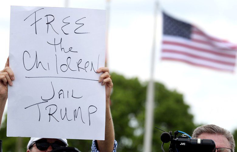Protester Melissa Houtte holds her sign while Sen. Bill Nelson and Congresswoman Debbie Wasserman Schultz address the media after being denied access to visit the Homestead Temporary Shelter for Unaccompanied Children on June 19, 2018 in Homestead, Fla. According to recent reports, there are about 1,000 migrant children currently being held at the Homestead facility some of whom were separted from their families at the border and others who were unaccompanied minors.   (Susan Stocker/Sun SEntinel/TNS)  1233895 1233895