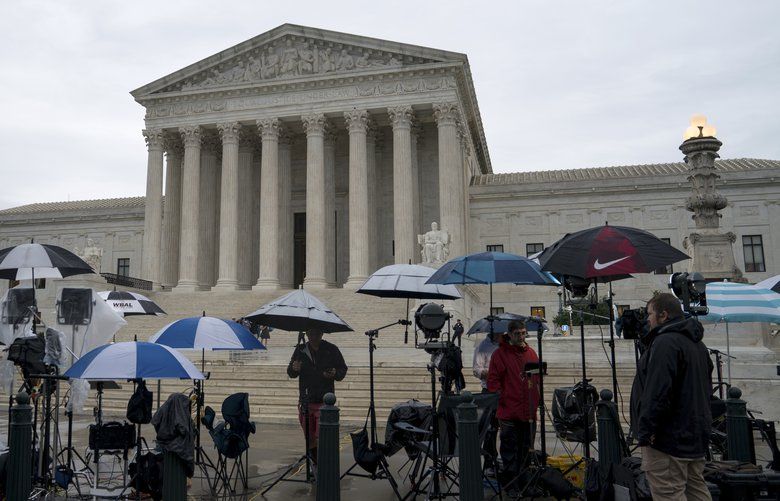 Television news crews wait for decisions outside the U.S. Supreme Court, in Washington, June 22, 2018. The court passed up an opportunity on June 25 to take another look at whether the Constitution bars extreme partisan gerrymandering, returning a case from North Carolina to a trial court there for a further examination of whether the challengers had suffered the sort of direct injury that would give them standing to sue. (Erin Schaff/The New York Times) XNYT5 XNYT5