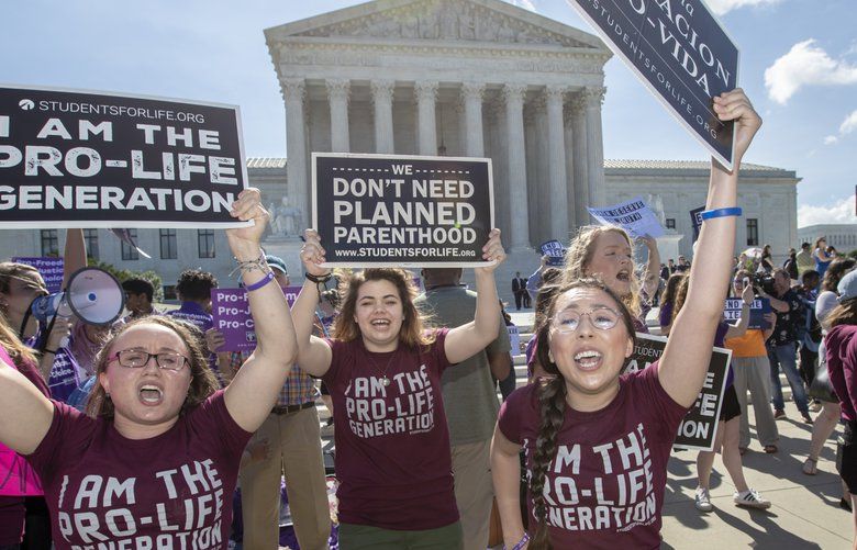 Pro-life and anti-abortion advocates demonstrate in front of the Supreme Court early Monday, June 25, 2018. The justices are expected to hand down decisions today as the court’s term comes to a close. They are waiting a decision from the justices on crisis pregnancy centers, the facilities established by pro-life organizations around the country to counsel women against abortion. (AP Photo/J. Scott Applewhite) DCSA107 DCSA107