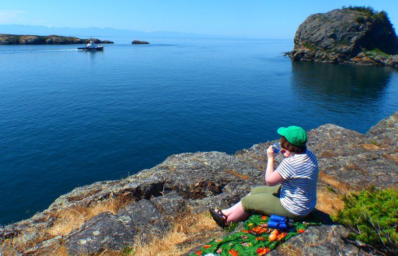 A tugboat threads between Castle Island, right, and Colville Island as a hiker eats lunch on the rocks at Point Colville, on the southeast tip of Lopez Island.
freelance/ one time use