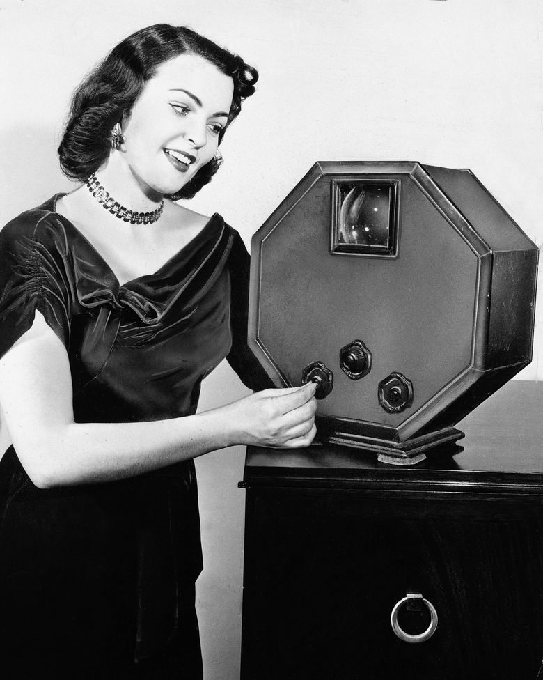 Marjorie Adams, Miss Chicago of 1950-51, demonstrates a GE television with a 3-inch screen in Chicago in 1952. (AP Photo/General Electric)