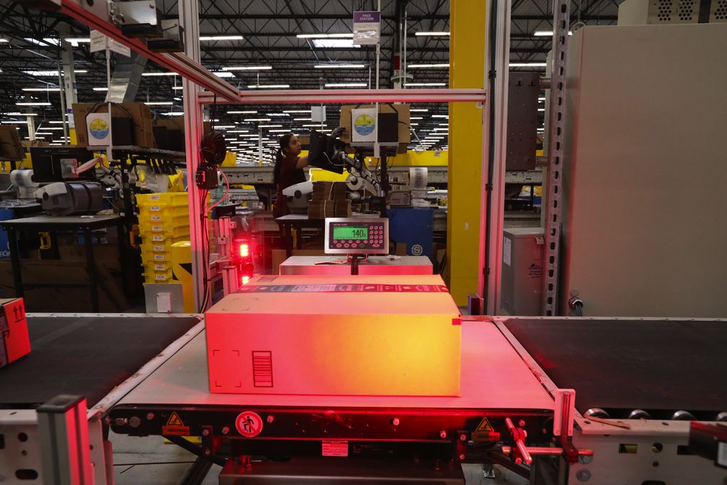 A package is weighed and its bar code is scanned at the Kent warehouse. (Alan Berner / The Seattle Times)
