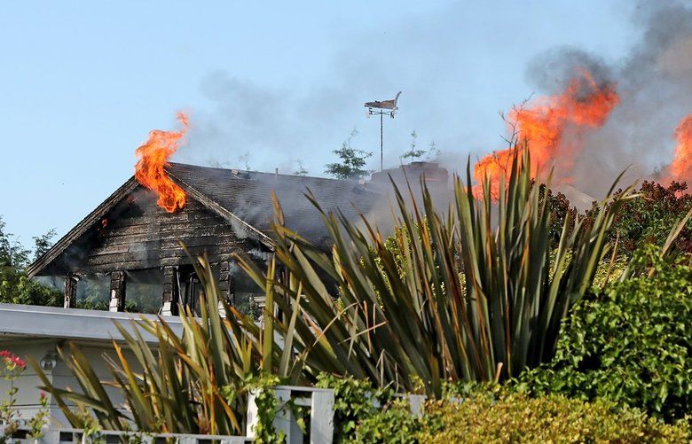 On June 11, 2018, flames engulf a building to the rear of a home at 2137 NW 96th Street.   206627