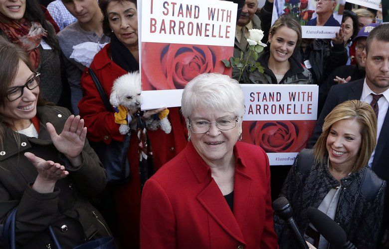 Barronelle Stutzman, center, a Richland, Wash., florist who was fined for denying service to a gay couple in 2013, smiles as she is surrounded by supporters after a hearing before Washington’s Supreme Court, Tuesday, Nov. 15, 2016, in Bellevue, Wash. Stutzman was sued for refusing to provide services for a same sex-wedding and says she was exercising her First Amendment rights, but justices questioned whether ruling in her favor would mean other businesses could turn away customers based on racial or other grounds. (AP Photo/Elaine Thompson)
