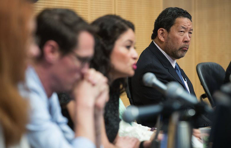 Council President Bruce Harrell, right, listens to testimony during the council meeting on June 12. 
The vote to kill the $275 per-employee tax represents a victory for Amazon and the other big businesses that would have paid it and have been funding a referendum campaign against it.