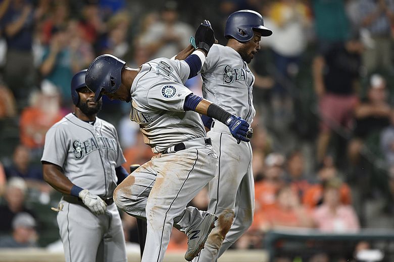 Seattle Mariners' Kyle Seager watches his three-run double against