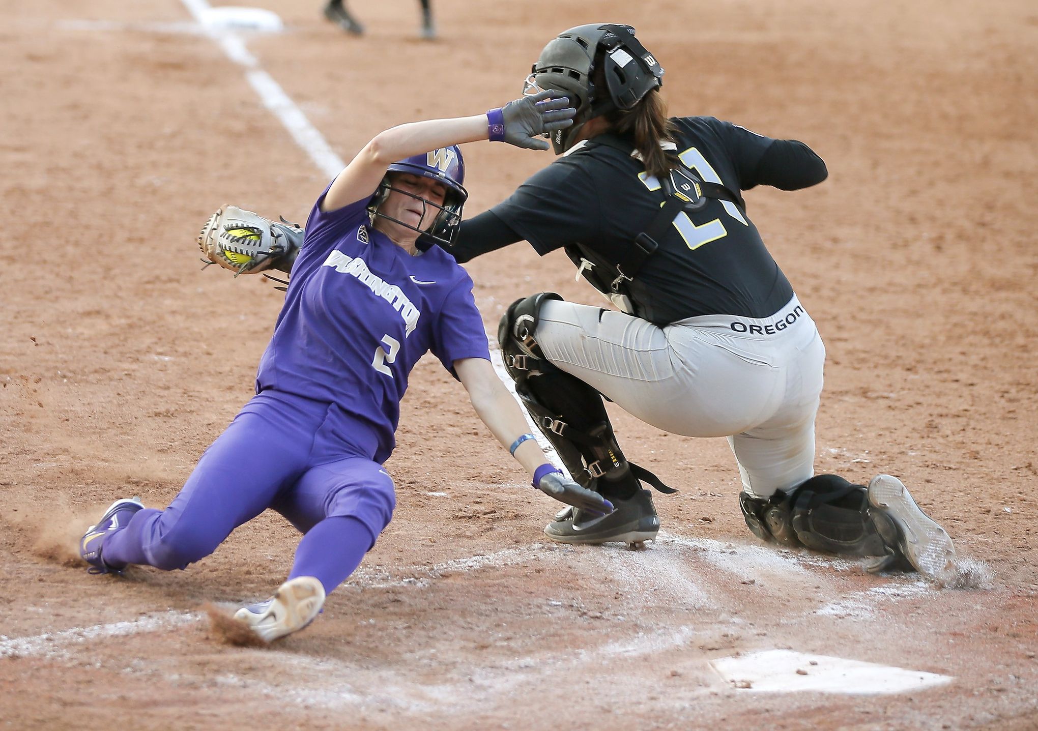 SEATTLE, WA - APRIL 17: Oregon Ducks catcher Terra McGowan (11) throws the  ball to first during a college softball game between the Oregon Ducks and  the Washington Huskies on April 17