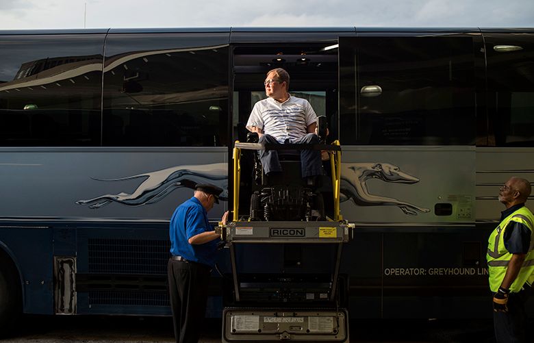 John Morris, a wheelchair user and a frequent traveler, exits a Greyhound bus using the wheelchair lift after arriving in Tampa, Fla., May 17, 2018. Apps help guide the blind through airports. Smartphones help the deaf communicate. But tech’s advantages often stop at the door of the plane, train or bus. “Oftentimes, I find myself being the one to educate the driver on how to operate the particular lift that’s set up on their bus,” Morris said. (Zack Wittman/The New York Times)